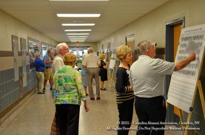 2015 Alumni Banquet June 13
Registration area: Joyce and Bill Gifford, `57, look on as two unidentified alumni view class graduations pictures from the past

